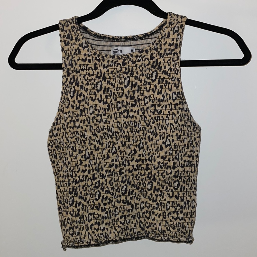 A women’s medium, cream colored crop top tank from Hollister.